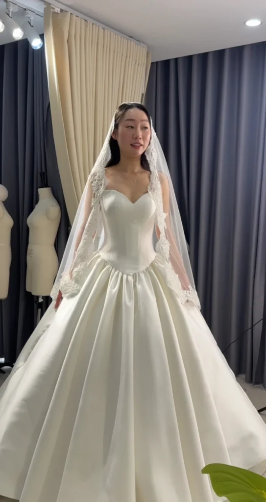 Váy cưới tay dài, cổ tim, chân váy xoè mặc cùng voan dài, chụp tại studio LAM’S